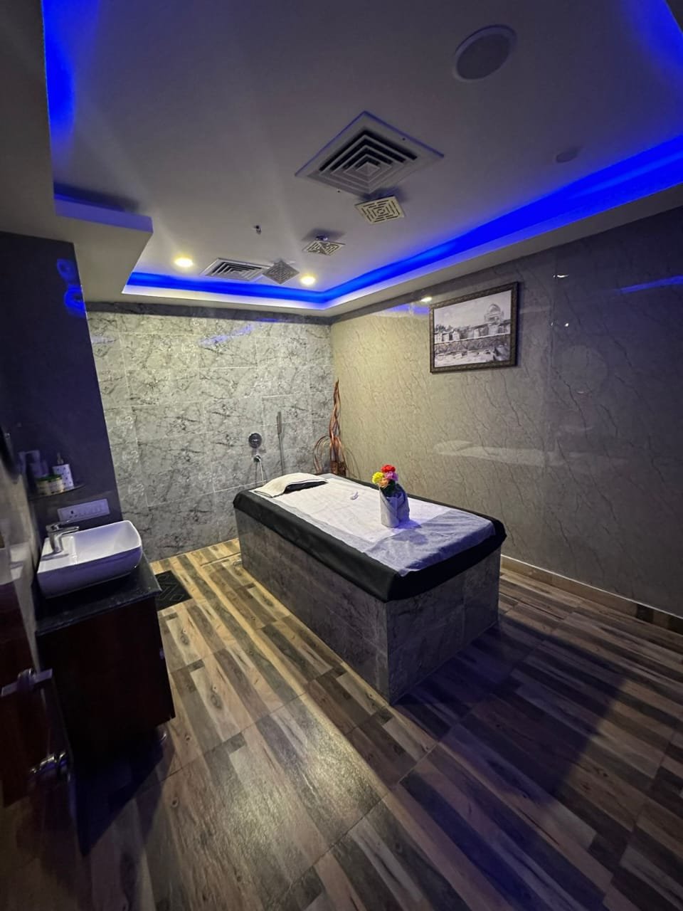 Modern spa room at Sunshine Wellness Spawith soft lighting and comfortable massage tables